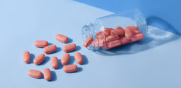 HIV/AIDS therapy pills on blue background