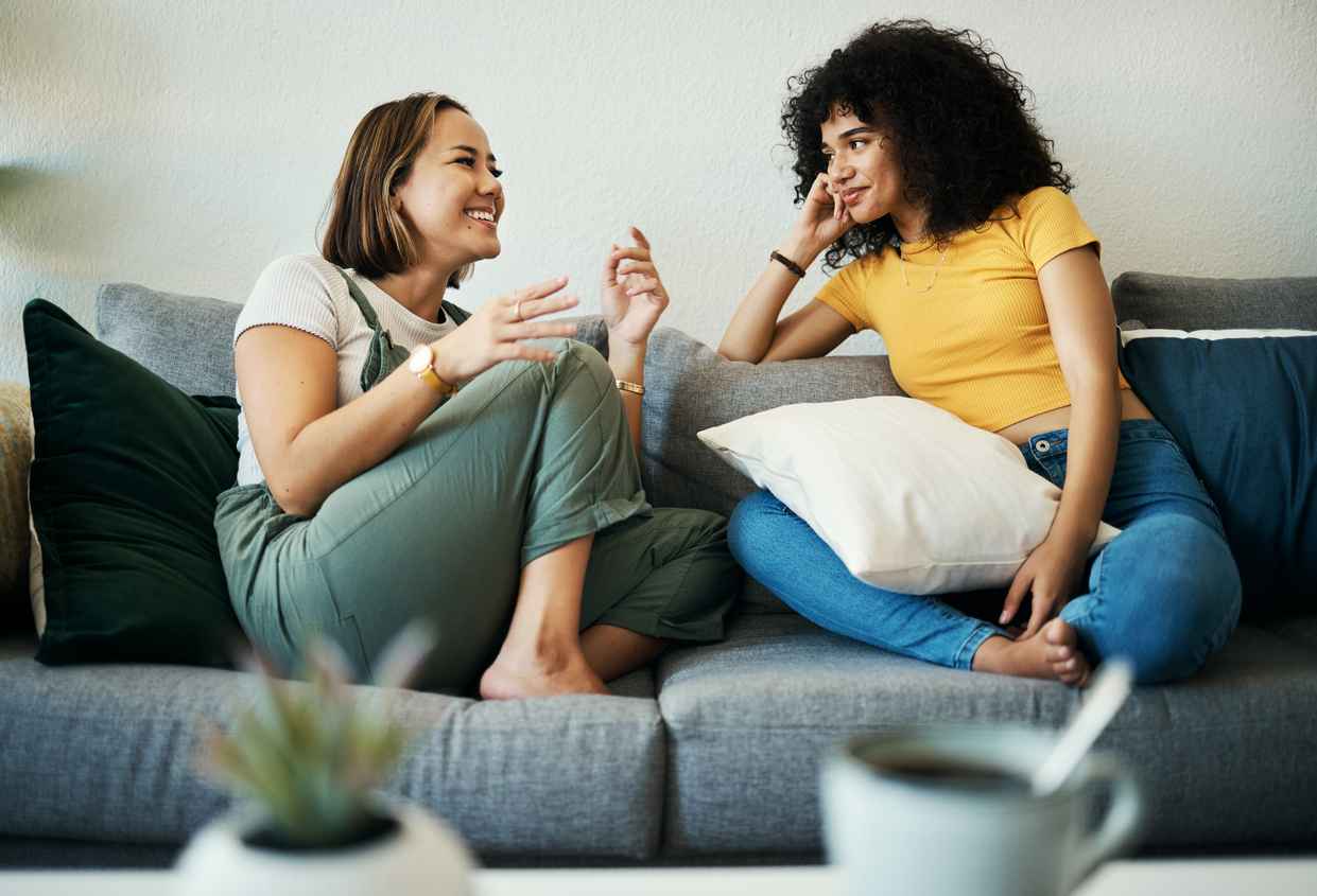 Two women having a comfortable conversation on a couch