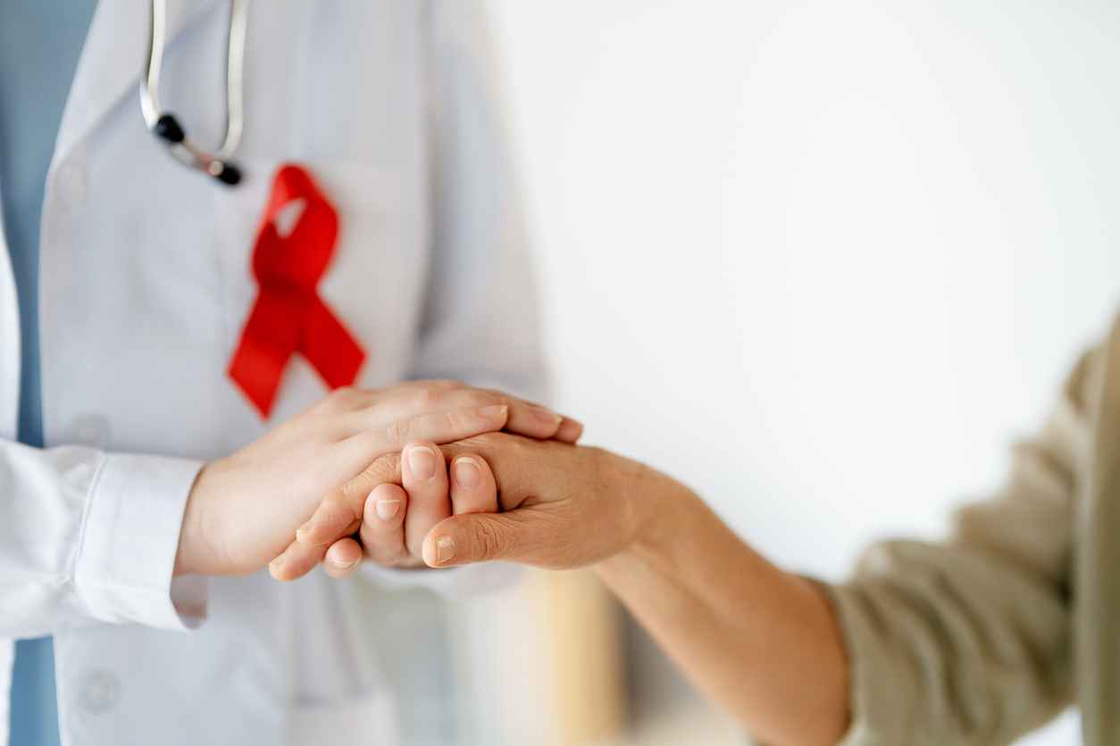 patient with a doctor wearing a red ribbon in medical office